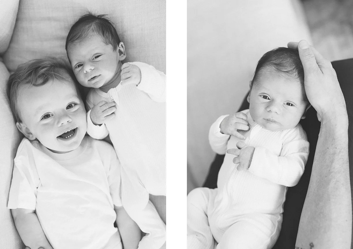 black-and-white-photo-newborn-baby-and-toddler-sibling-looking-at-camera.jpg