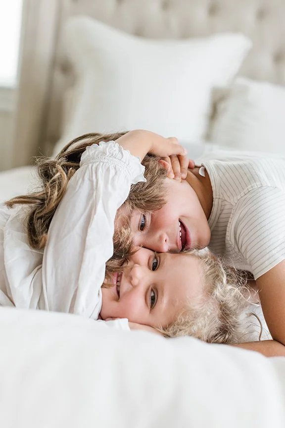 young-siblings-playing-on-bed.jpg