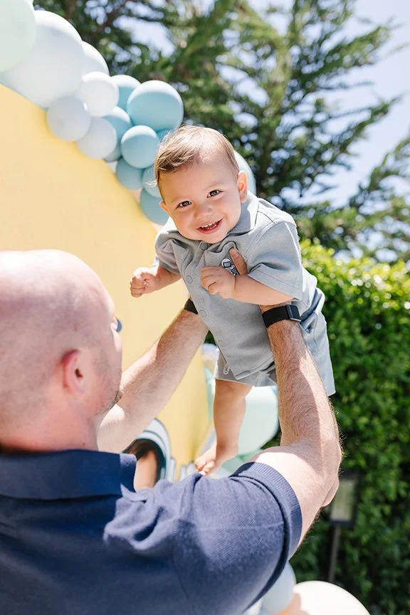 baby-boy-up-in-air-in-dads-arms.jpg
