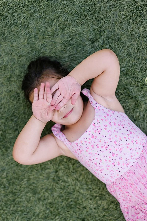 little-girl-taking-break-on-grass.jpg