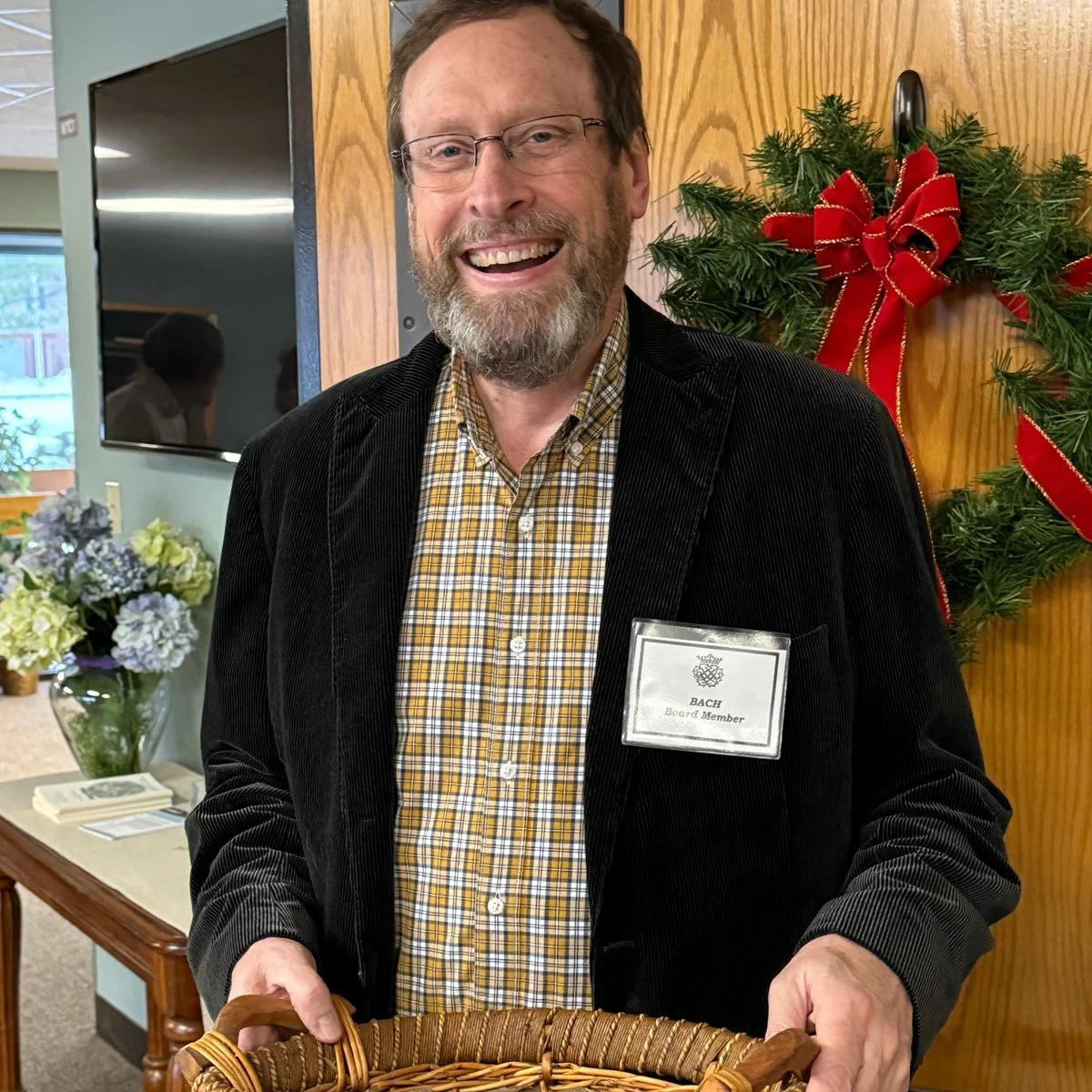 Volunteer distributes Messiah Sing-along programs