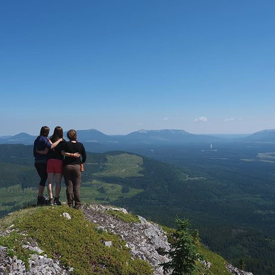Navarana, Julie, and Sandra pause to take in the stunning scenery from a mountain peak.
