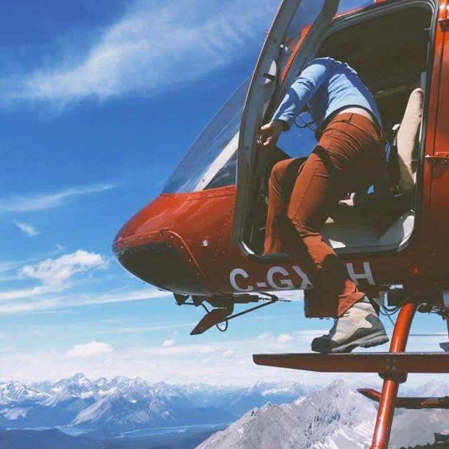 Sonia climbs into a helicopter and flies away after repeat-photographing the Mt. Odlum Station (see historical image here ). Photos by Alex Hakonson.