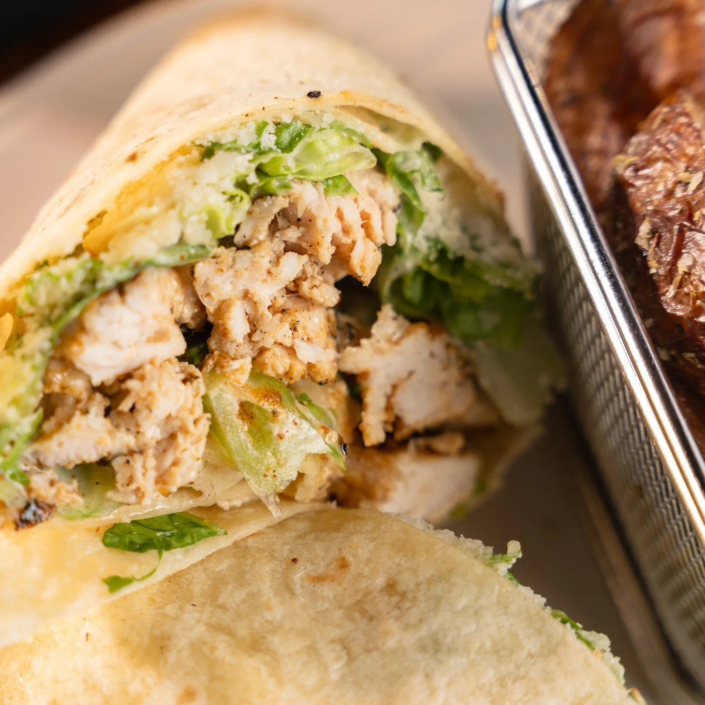 A little spice, a lot of crunch and all the Caesar flavor. Our Blackened Chicken Caesar Wrap combines blackened grilled chicken, crisp romaine, Parmesan and creamy Caesar dressing, all wrapped up in a flour tortilla.