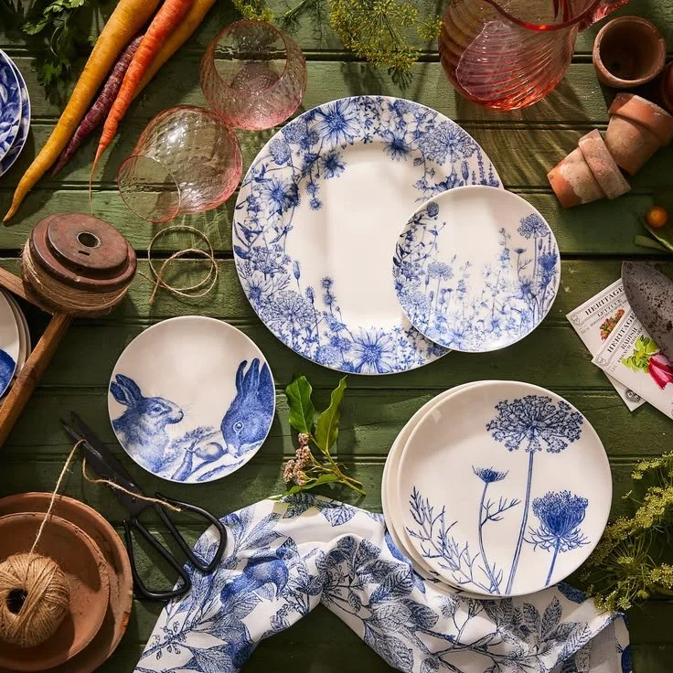 Blue floral dinner plate styled on a table with linen and light blue glass, creating a soft and inviting spring setting