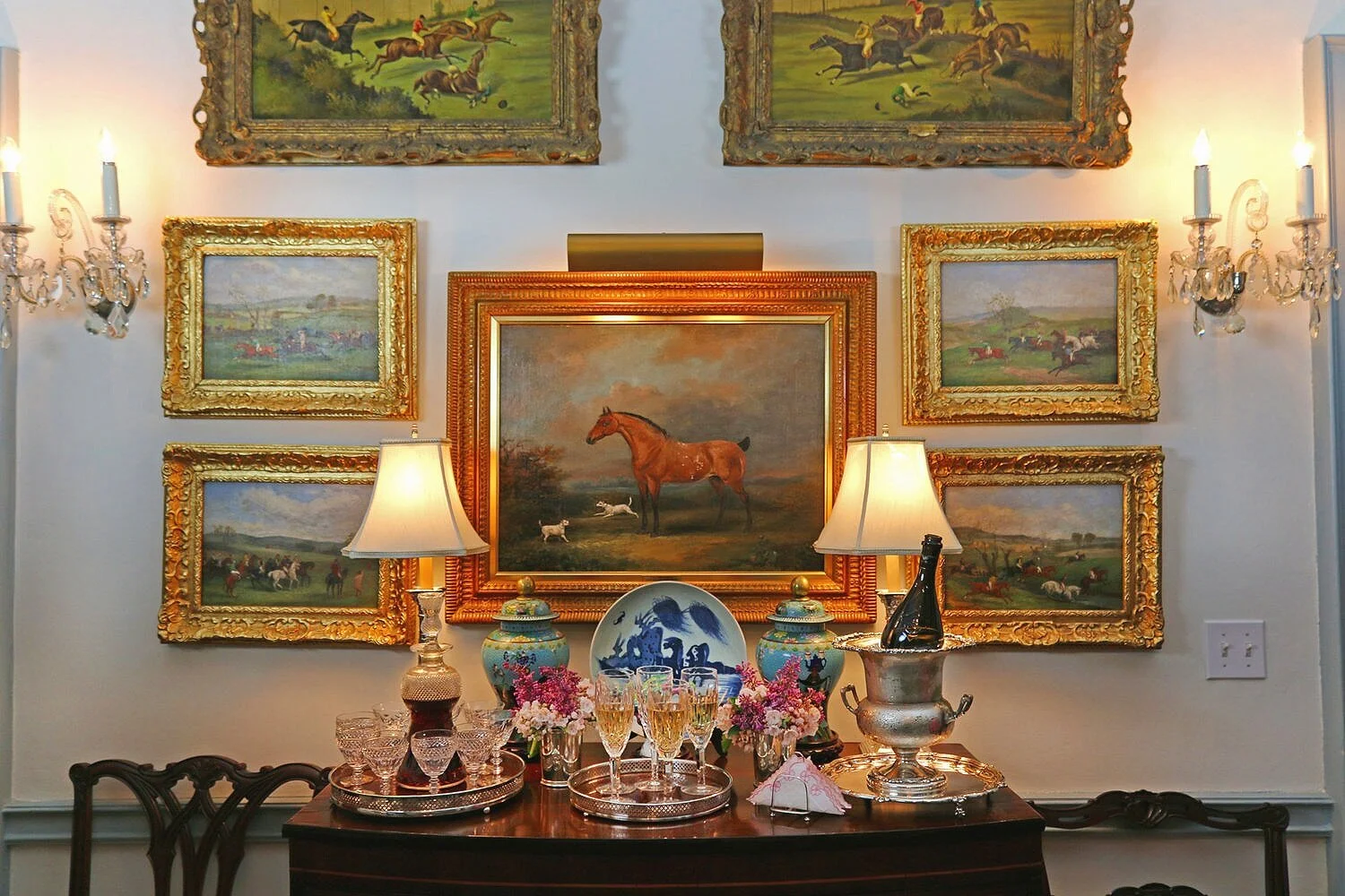 A small vignette in Holly’s home when entertaining for a crowd. I love all the small nuances like the sterling silver trays and large mint julep cups used as vases. The artwork is so special to Holly’s family. Perfect in this lovely setting.
