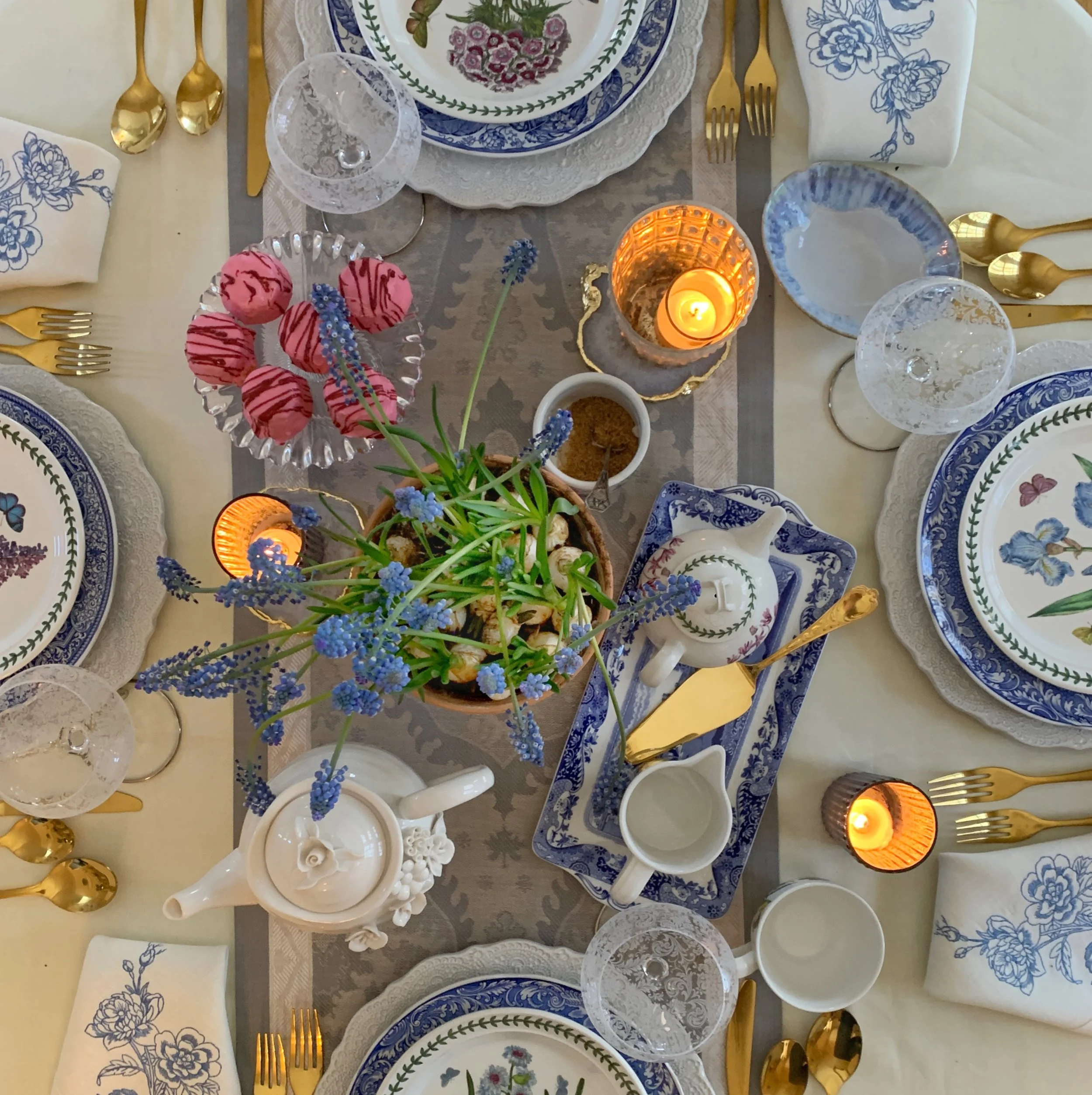 spring botanical garden table with portmeirion dishes and blue and white vintage china styled with grape hyacinth centerpiece