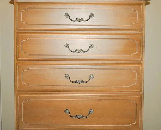 A solid birch chest of drawers with a soft hand-painted streaked finish, the foundational furniture of a daughter's bedroom.