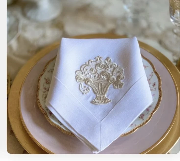 European linen napkin with woven basket embroidery styled in an elegant table setting.