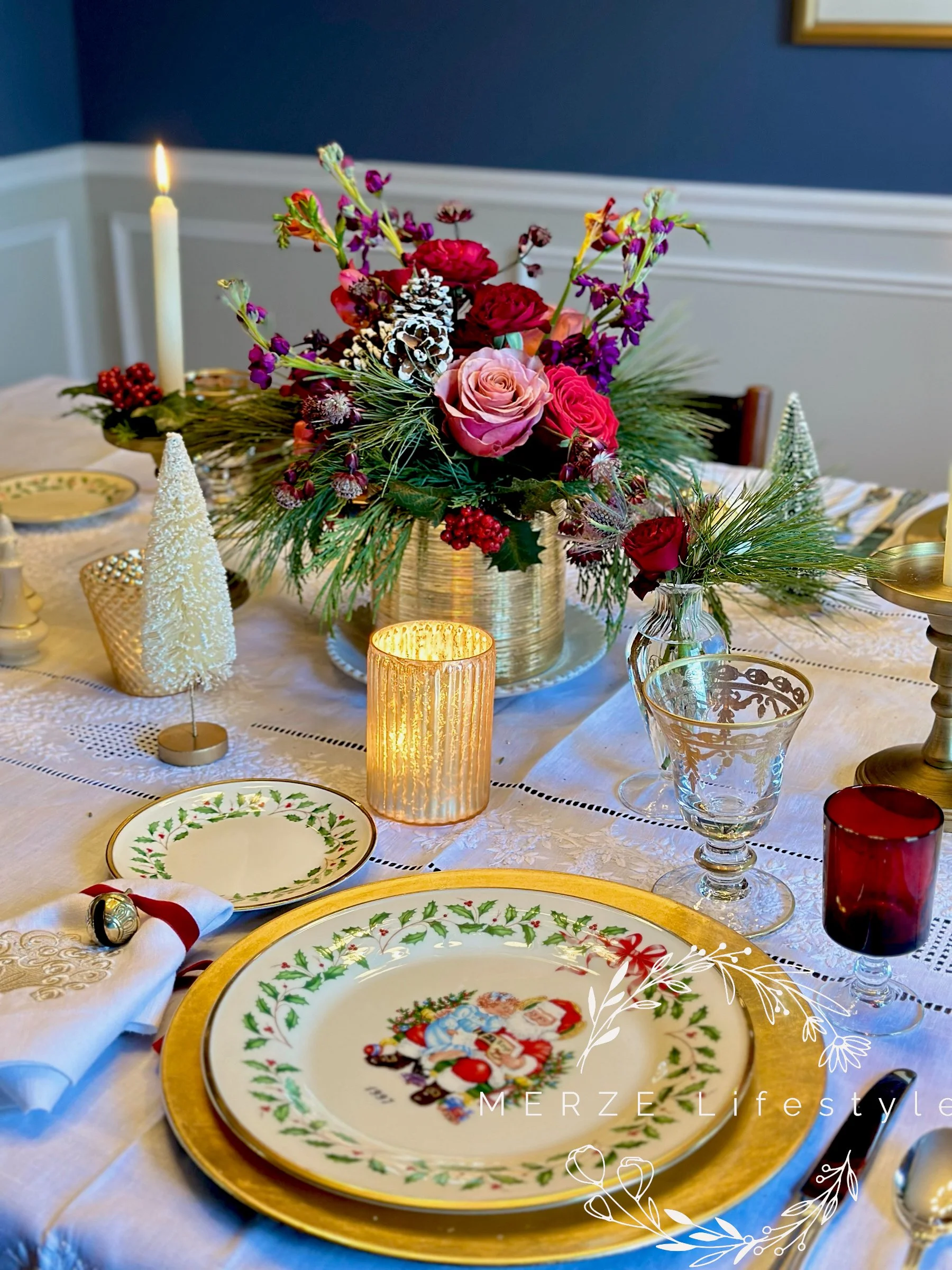 Linen napkin styled with red ribbon and a gold bell for a traditional Christmas table setting.