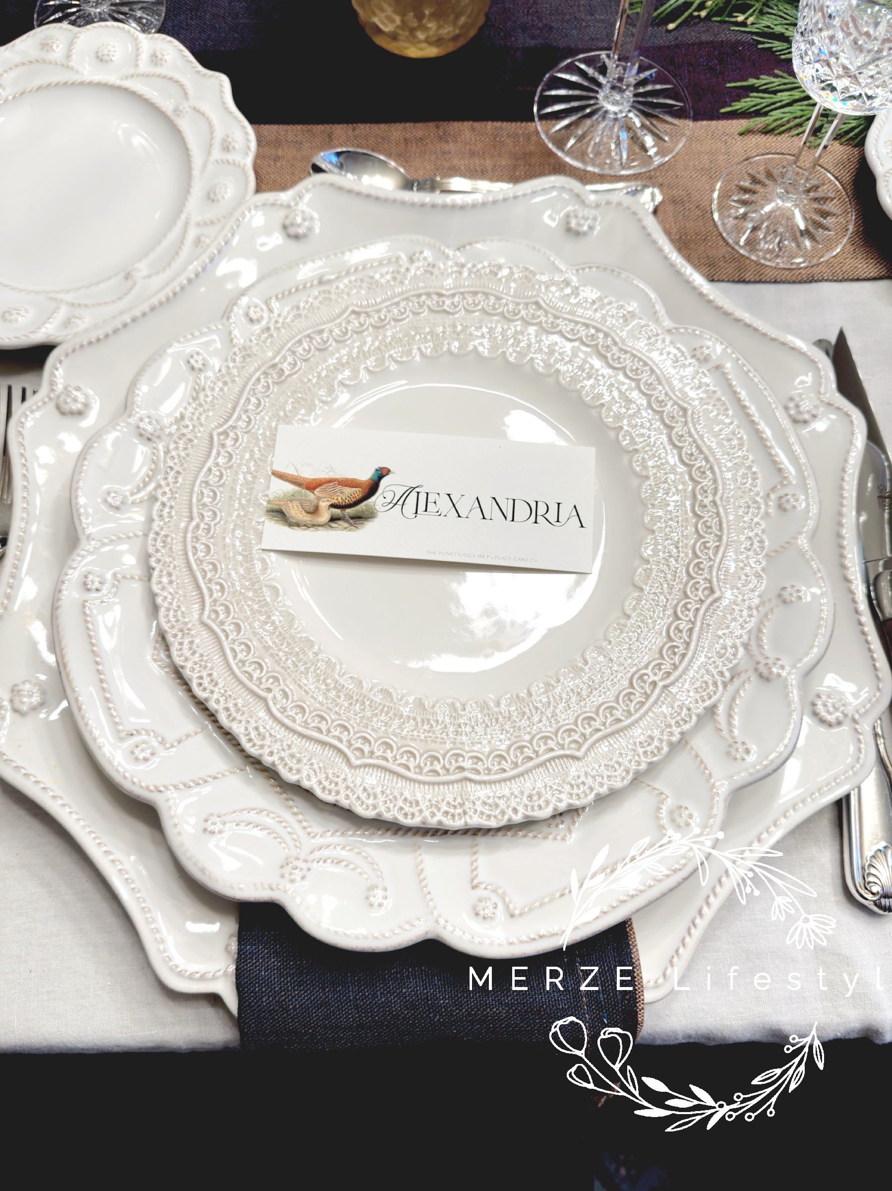 Close up of cream layered plates with woven runner and patterned textures