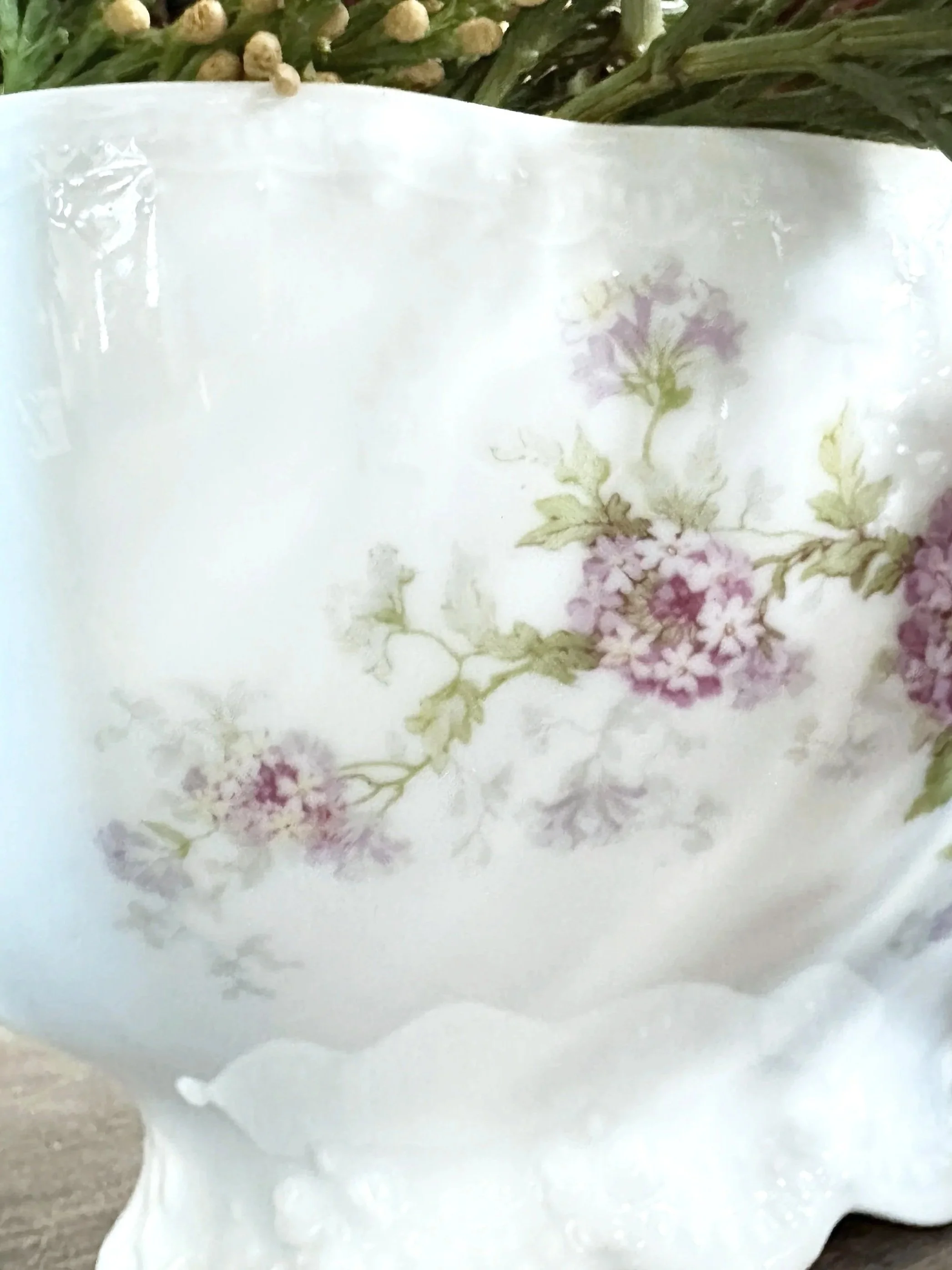 Antique white soup tureen used as floral centerpiece with subtle color echo