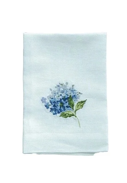 European linen napkin embroidered with blue and white hydrangea flower detail.