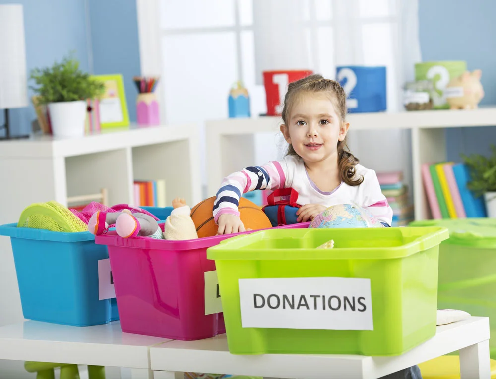 Photo: Child organizing bins for toy donations.&nbsp;