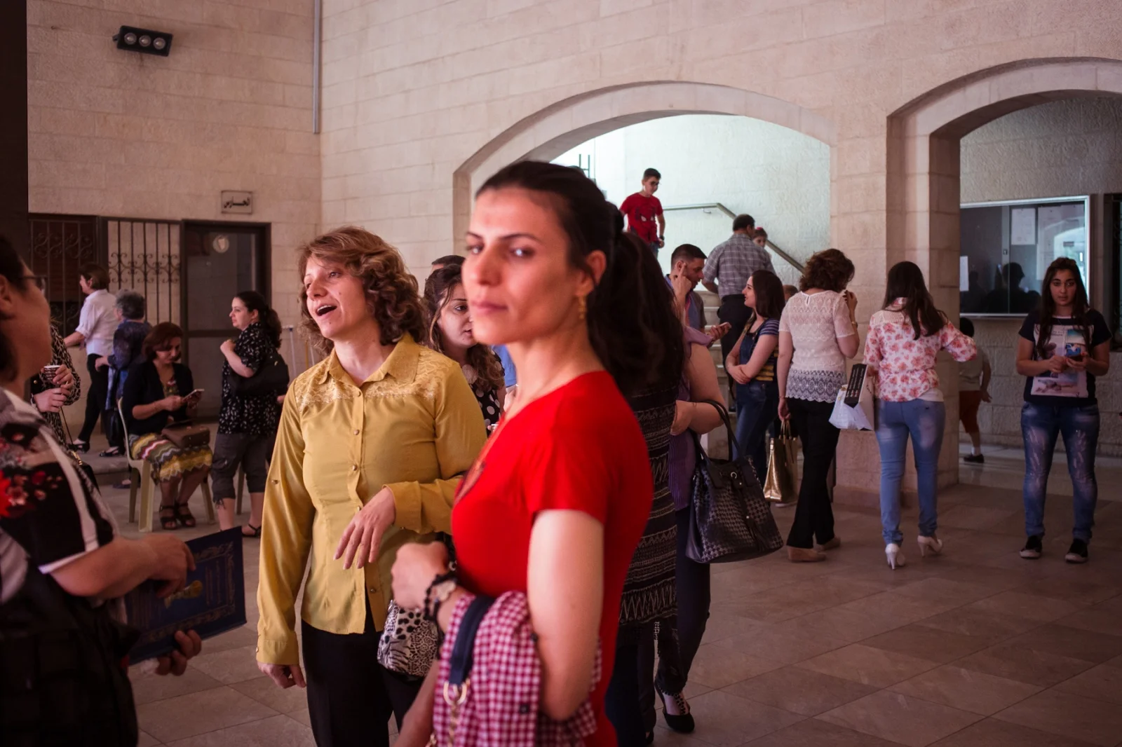 Iraqi Assyrian women chat with each other after a church service in Amman, Jordan. While there were a small number of Jordanian Assyrian Christians, the church’s congregation more than doubled after Christians and other minorities fled ISIS in 2013. The church provides buses to and from the church so its members can come from other parts of the city.