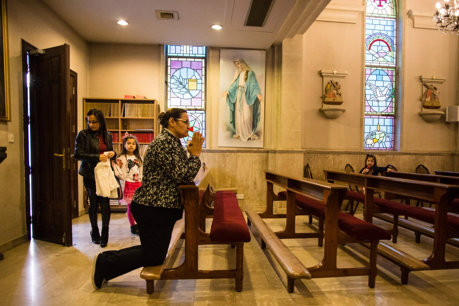 Farah (left), from Mosul, enters the church with her two daughters, Valentina, 7, and Faustina, 4. Farah was a civil engineer in Iraq, but now she and her husband are living off their savings, being unable to work in Jordan. She says the family have no plans to return to Mosul, saying it will still be too dangerous for Christians.