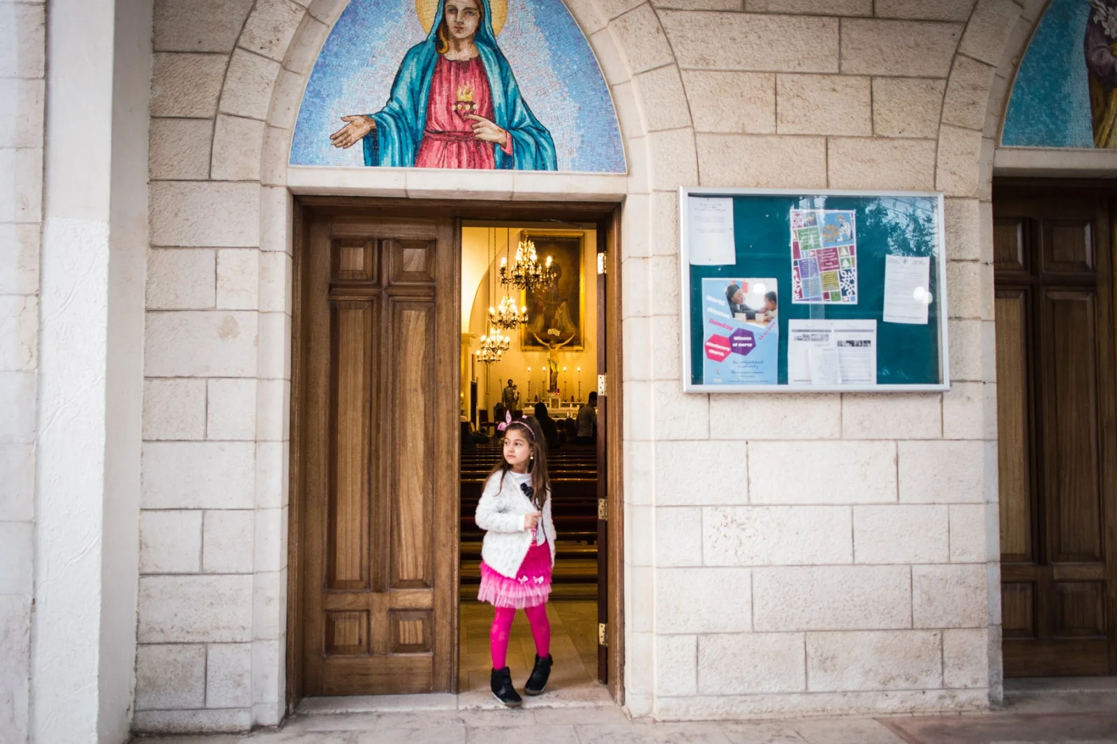 Valentina, 7, stands in the doorway of the Mar Youssef church in Amman, Jordan, on Nov. 4, 2016. She has lived in Amman with her family since fleeing Mosul over a year ago when ISIS took over.