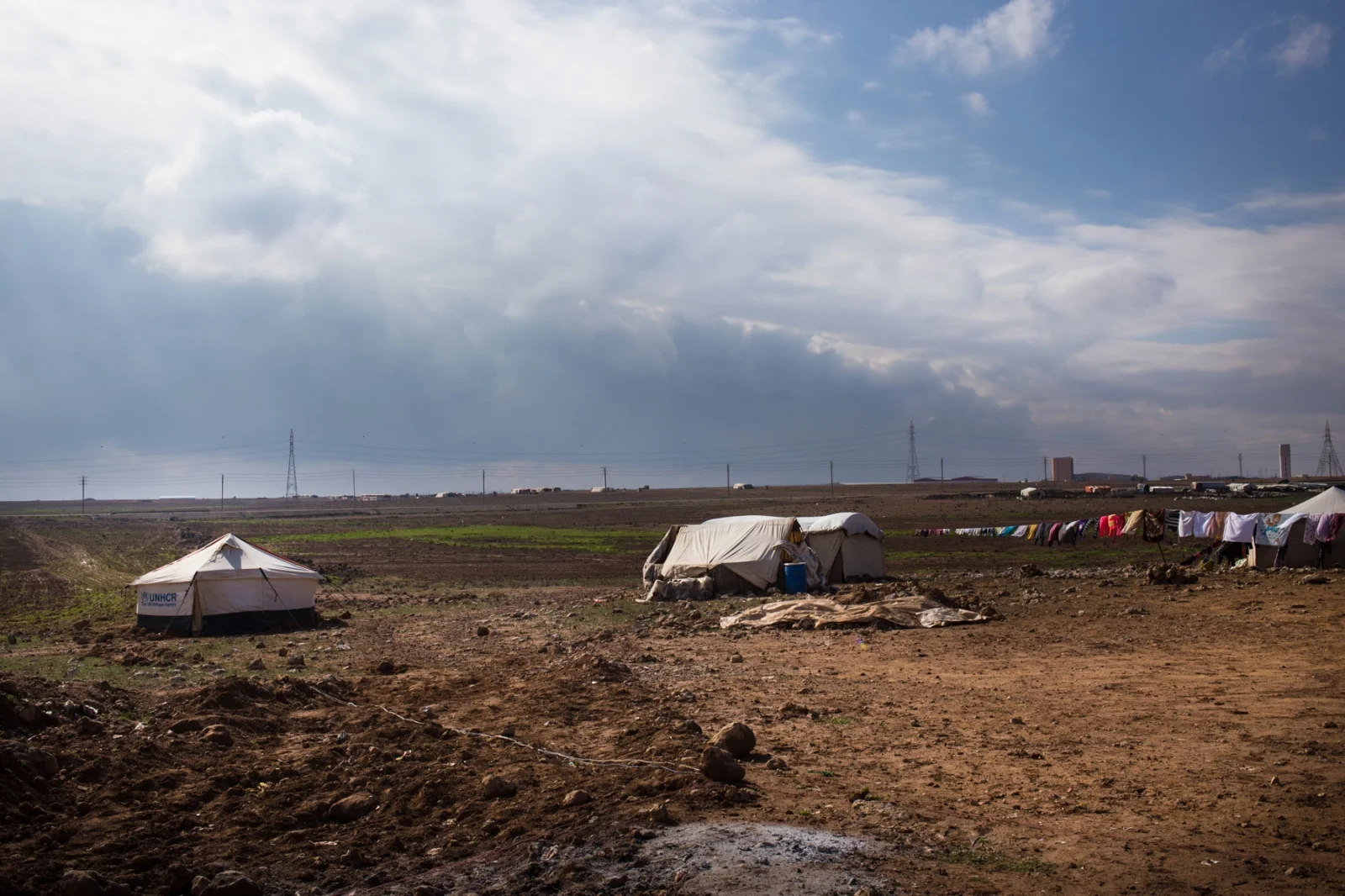 An informal tented settlement (ITS), home to about 20 Syrian refugees, sits on agricultural land close to the Syrian border.