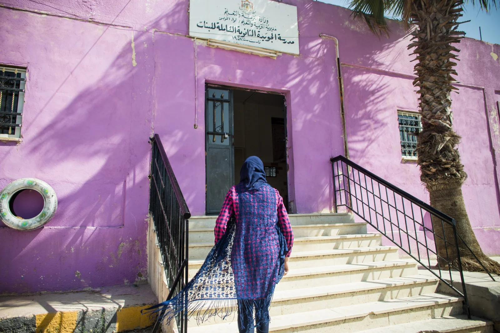 Rand Al-Bustanji walks into her school to pick up her younger sister and meet up with her friends.