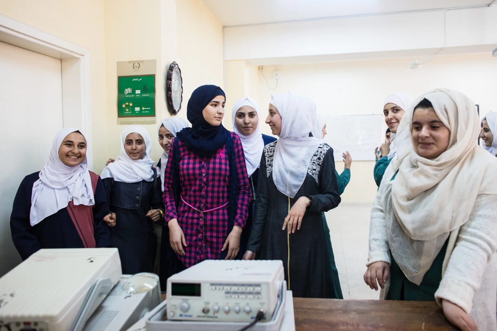 Rand Al-Bustanji (center) visits with her friends in their science classroom. Rand hopes to continue with sports, but also has aspirations of studying computer science in university.
