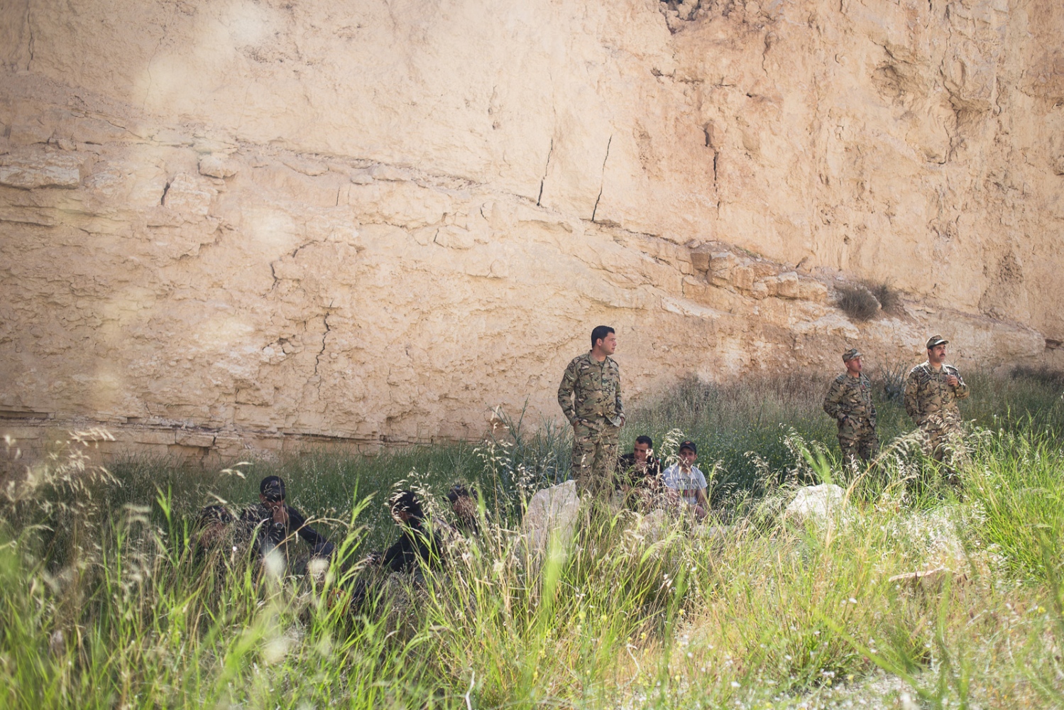  The Jordanian team rests in the shade of a sandstone cliff before the "urban assault" event at the Warrior Competition on April 21, 2015. In this event, soldiers must rush over a dirt verge, storm a building in a mock city, rescue a hostage and fire
