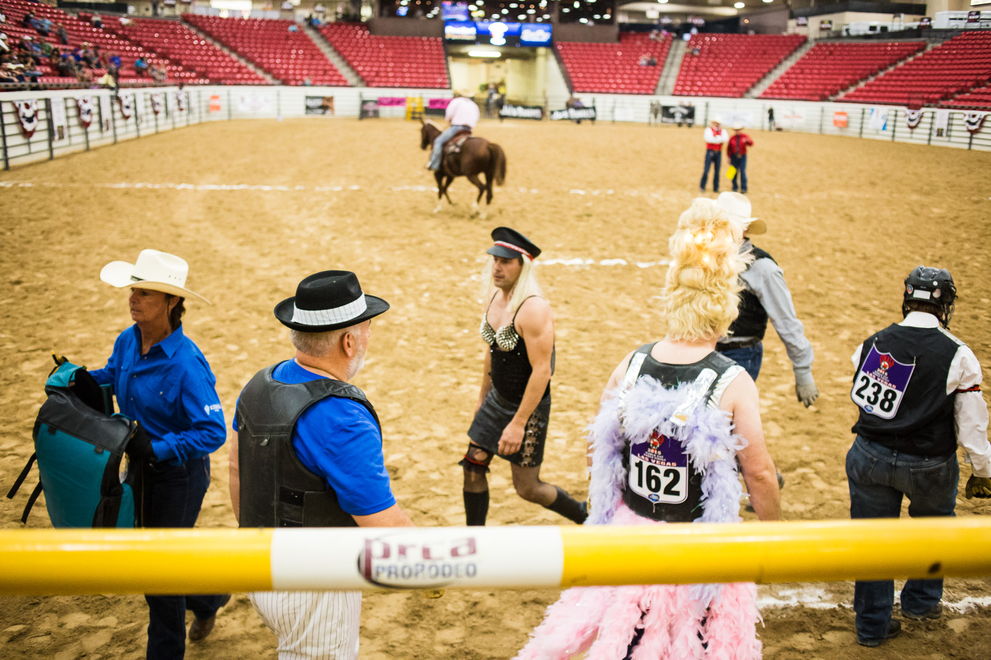 The Wild Drag Race is an event unique to the Gay Rodeo, which involves a 3-person team of a man and woman in costume, plus either a man or woman in drag. With the help of his/her teammates, the person in drag must try to mount a bucking steer after