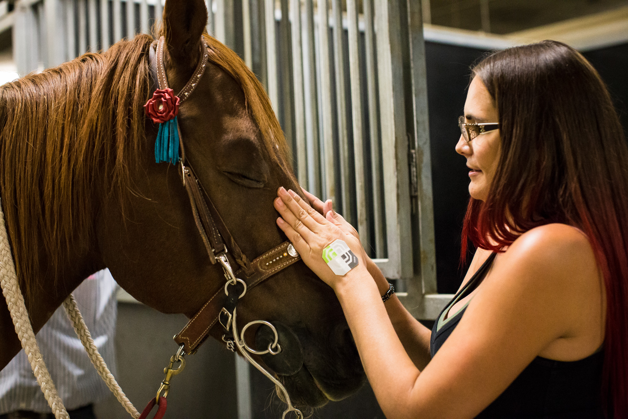 Britany Davis, of Boulder City, NV, gets her horse, Kid, ready for practice at the World Gay Rodeo Finals in Las Vegas, NV. "Kid's really a barrel horse, so I don't know how we'll do in pole bending, but I thought I would come and have fun with it s