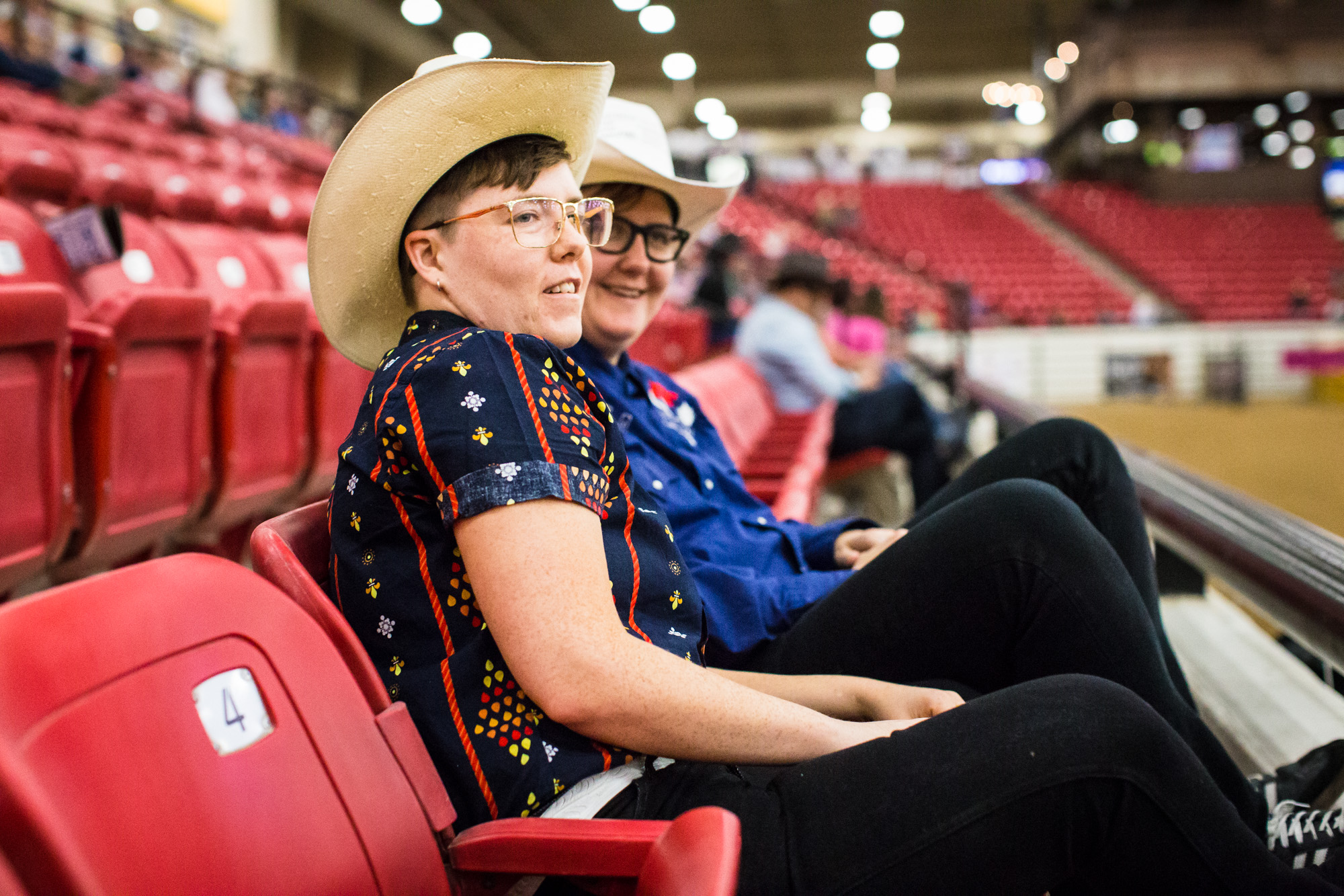 Amanda Kirkhuff and Clyde Petersen watch the Pole Bending event at the World Gay Rodeo Finals in Las Vegas, NV. Amanda grew up going to rodeos, but enjoys the open environment of gay rodeos. "You always see gay people at rodeos, but it's just unspok