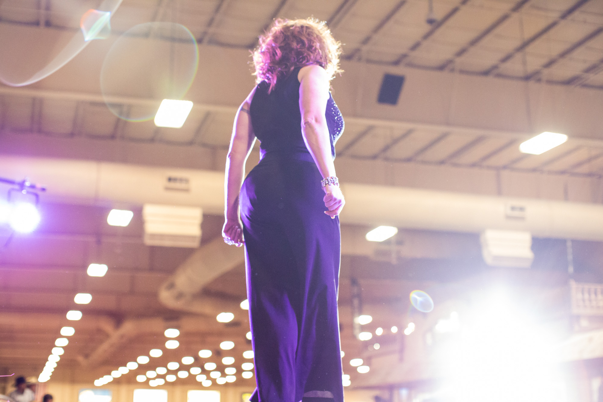 Rebecca Tucker, a contestant for Miss IGRA 2015, performs a song and dance as part of the Royalty Competition at the World Gay Rodeo Finals in Las Vegas, NV.