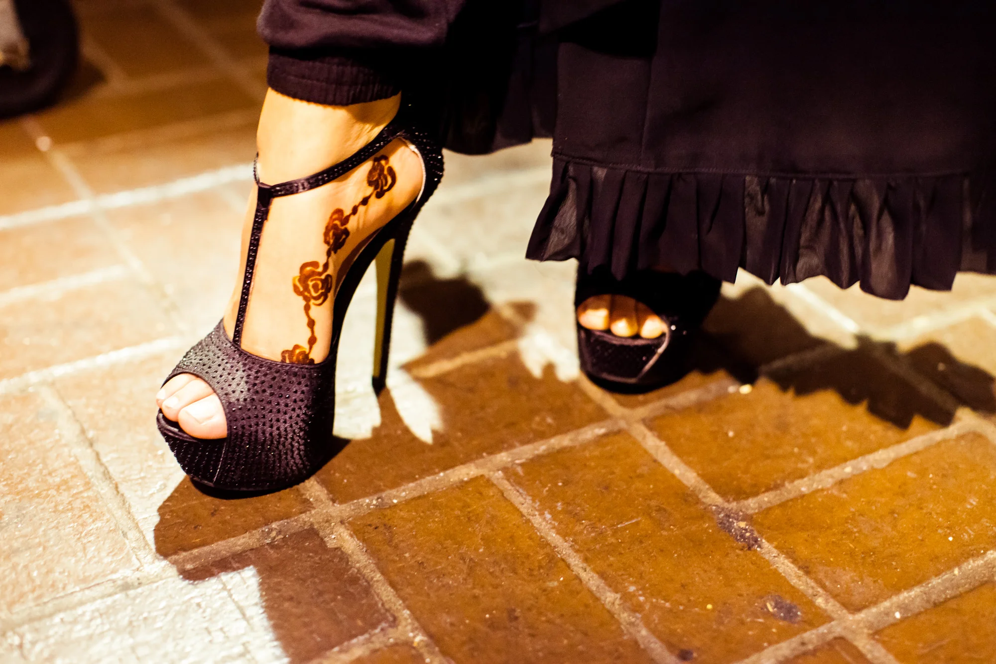 A model shows off her henna tattoo with her stilettos backstage at the RAHMA fashion show in Washington, DC.