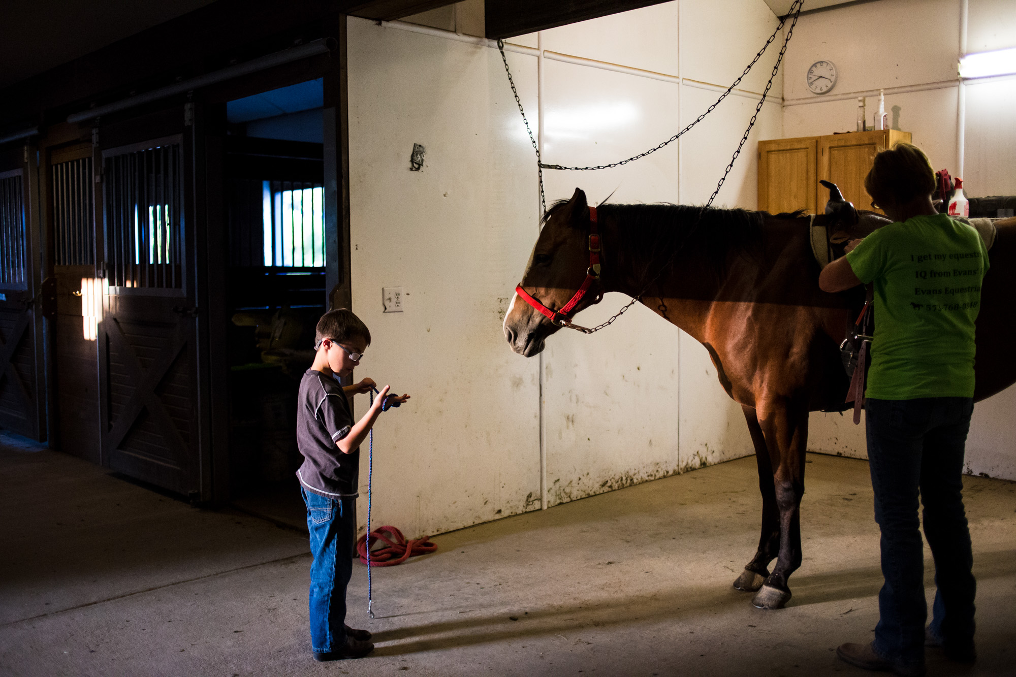 Treven’s instructor, Krystal, shows him how to take care of the horse after his therapy session. The therapy is meant to help Treven develop his motor skills, build muscle strength, and deal with sensory issues that come with being around animals an