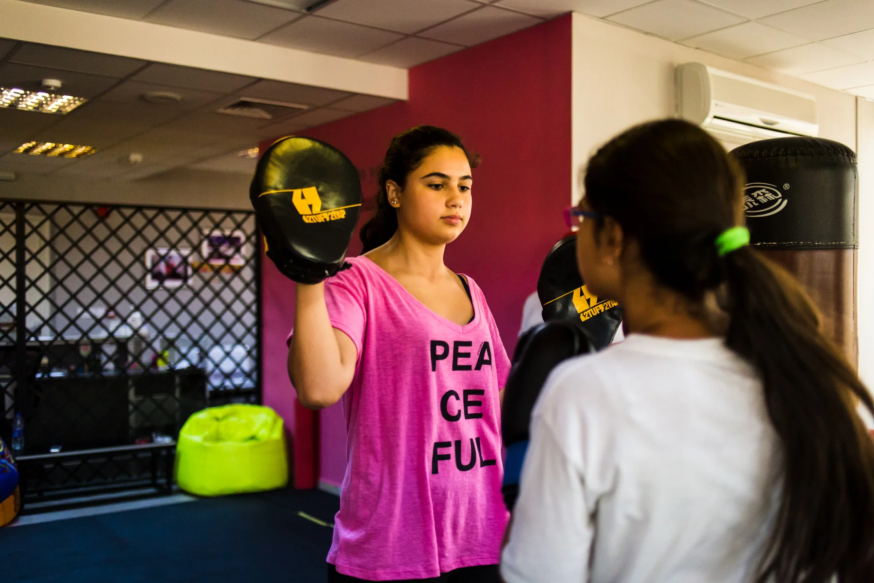 Zaina and Juwana Ghosheh practice high kicks during a self defense course at She Fighter in Amman, Jordan, on August 21, 2015. The She Fighter studio was founded by Lina Khalifeh, and offers self defense classes to young women to protect against harassment.