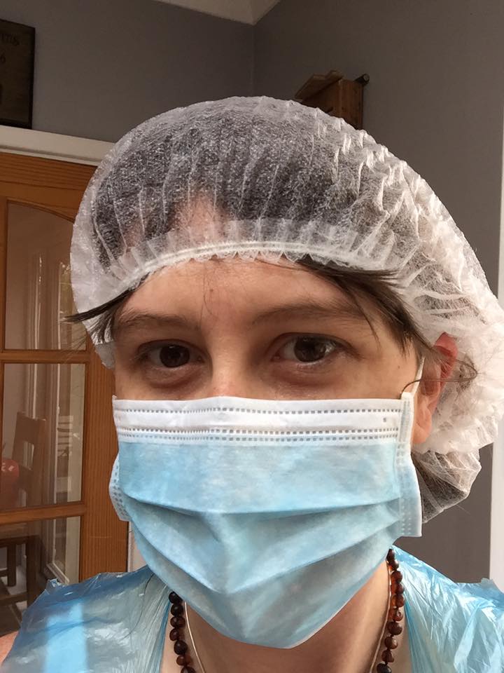 Sarah Marsden all gowned up to prepare placenta remedies for her postpartum mums.