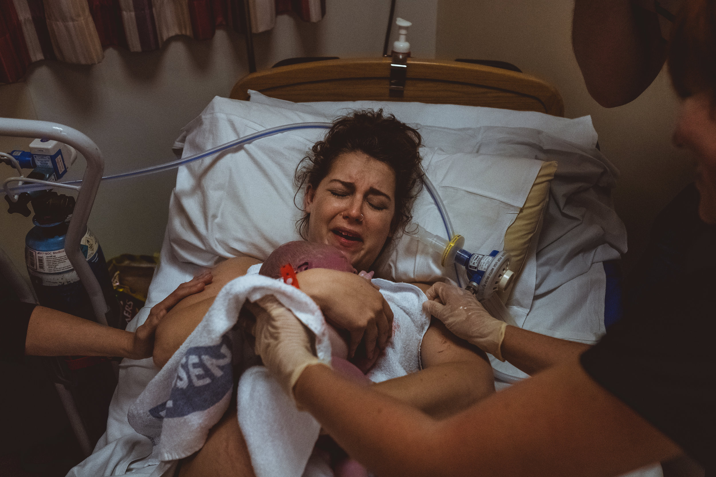 A mother greets her fresh baby with joy after the birth at Royal Derby Hospital, Derbyshire