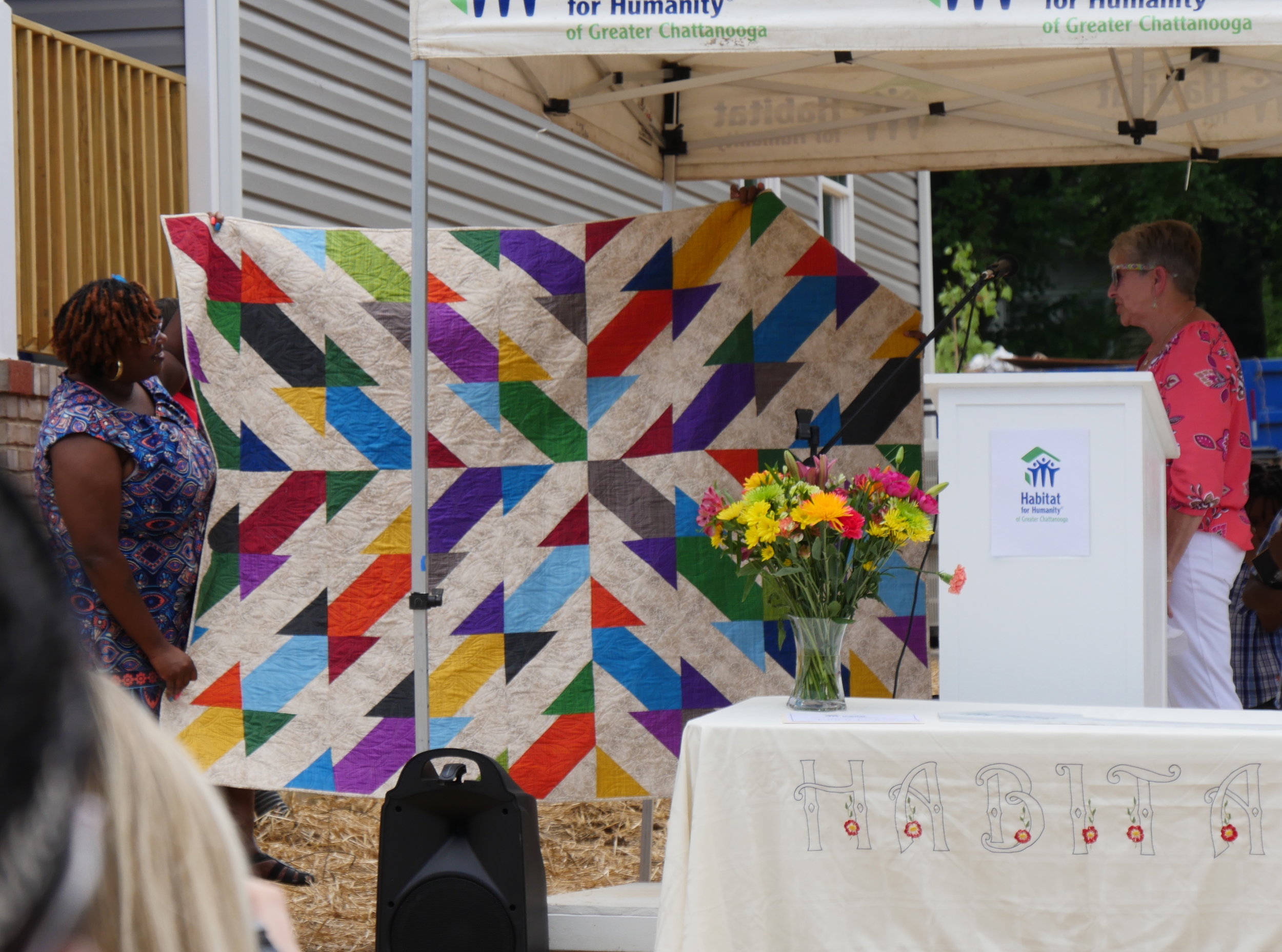 Fanetta (left) loves her colorful quilt. Photo courtesy of Habitat for Humanity of Greater Chattanooga.