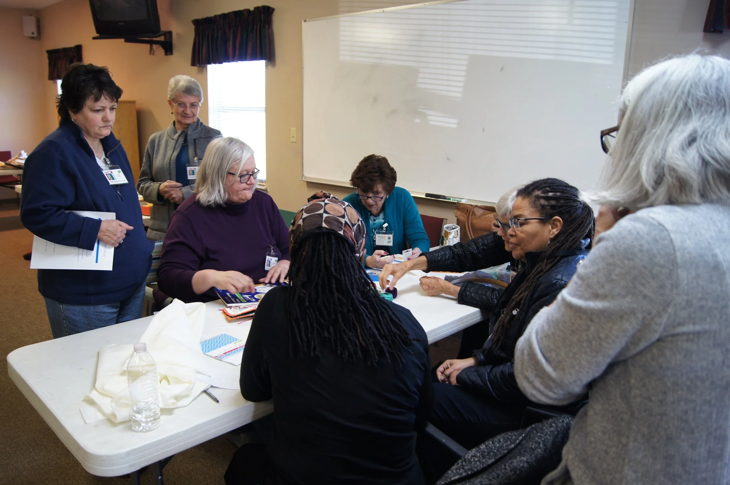 Janet Suber shows ChattMQG members how to embroider words on quilts.