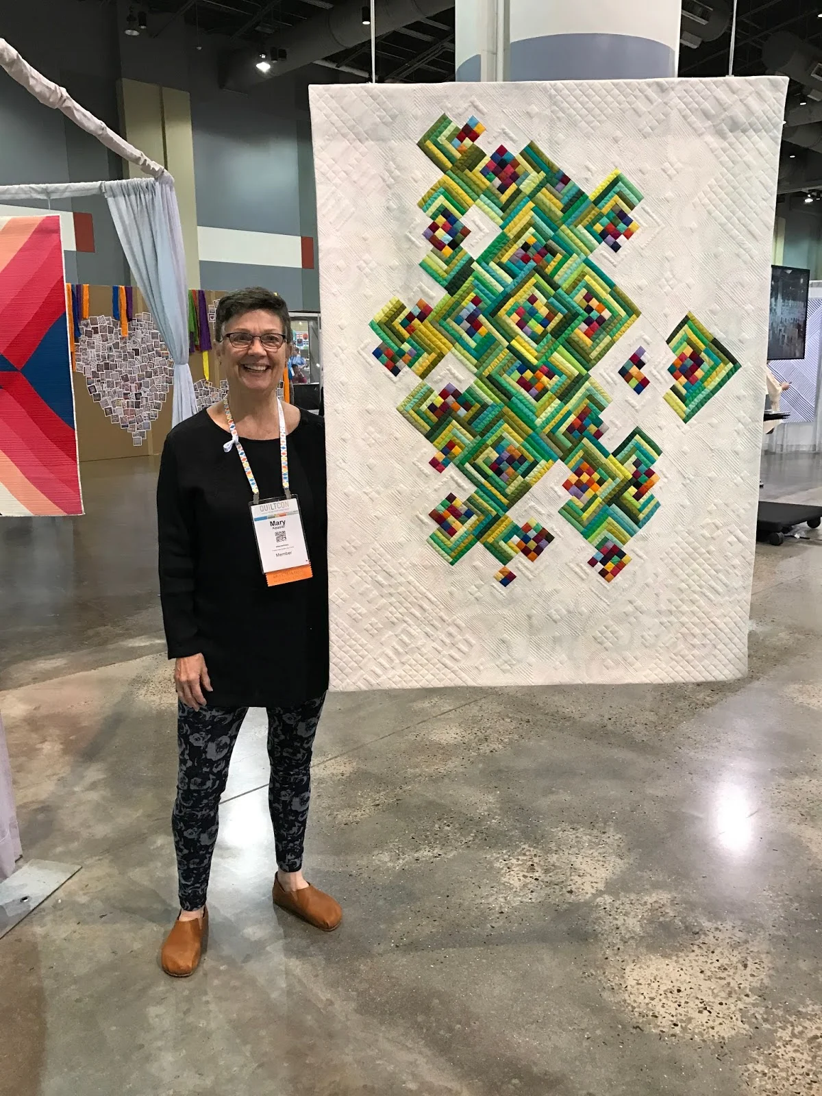 Mary Keasler and her award-winning quilt "Not Easy Being Green"