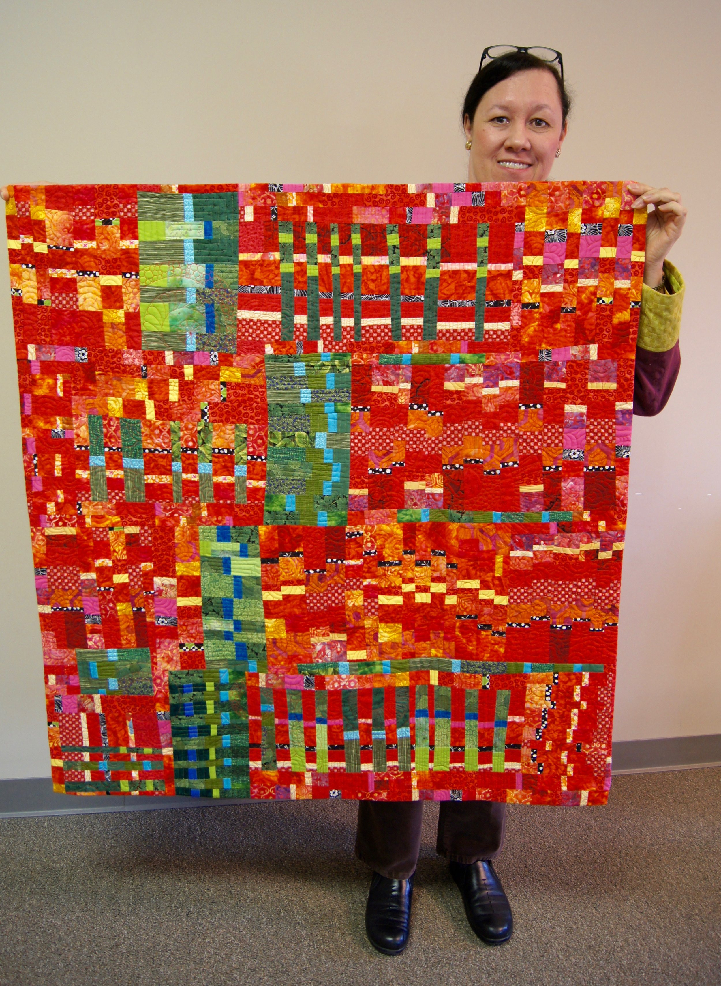 Veronica Hofman-Ortega's "Guitar Strings Improv" quilt, which is featured in a book by Sherri Lynn Wood