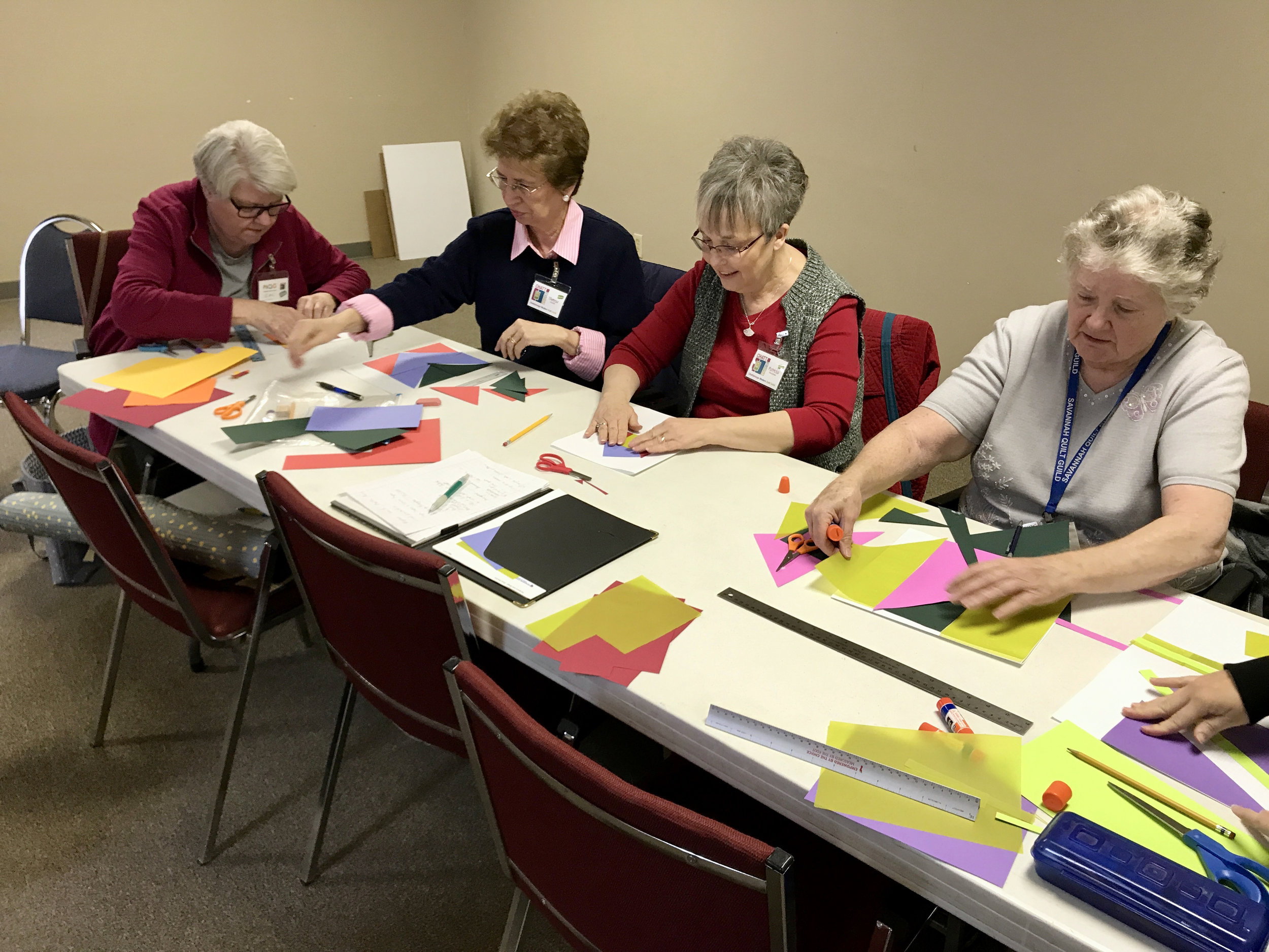 Jean, Theresa, Patricia, and visitor Helen work on their paper blocks