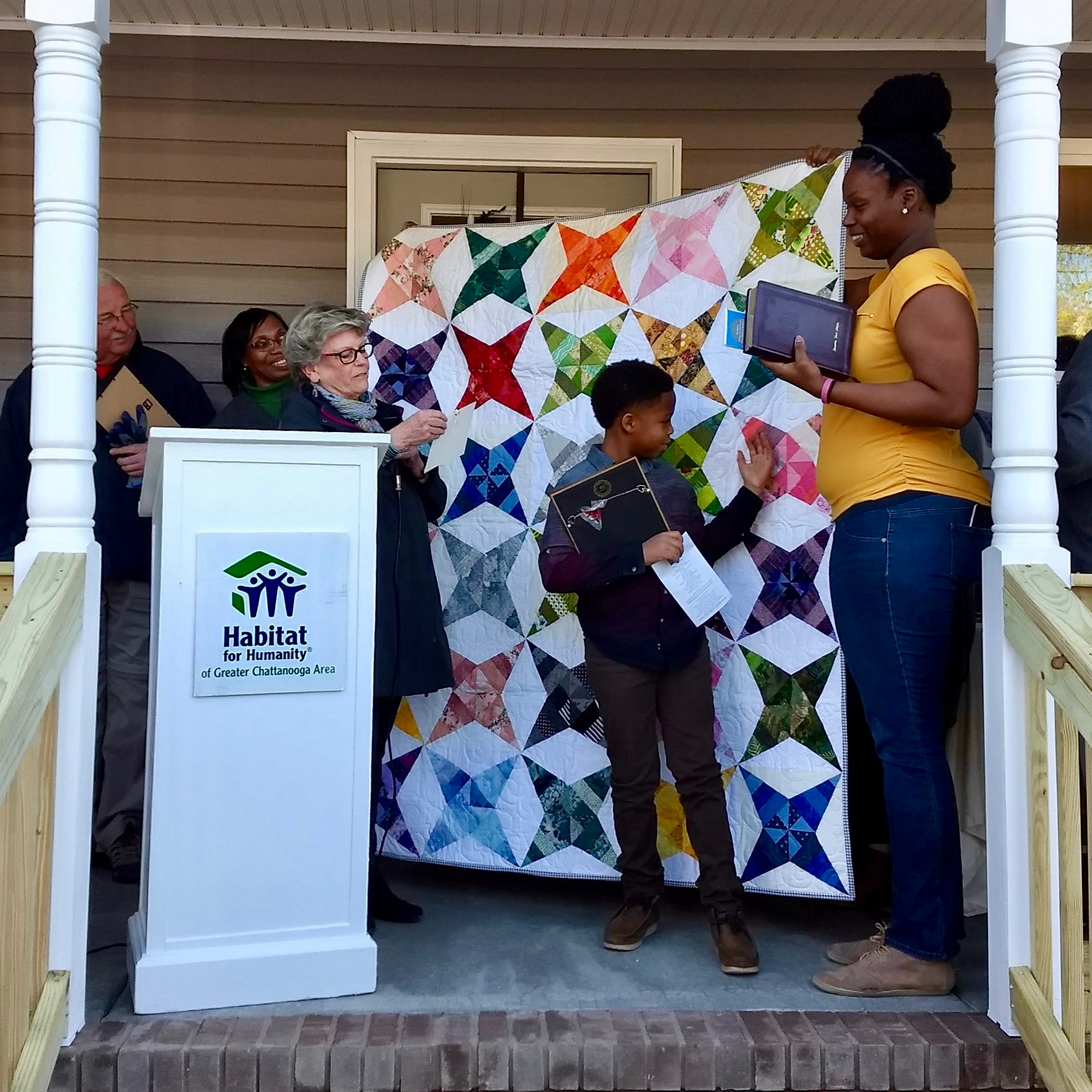 Shan Melvin (right) receives our paper-pieced star quilt at the March 22 dedication ceremony. Photo courtesy of Habitat for Humanity of Greater Chattanooga.
