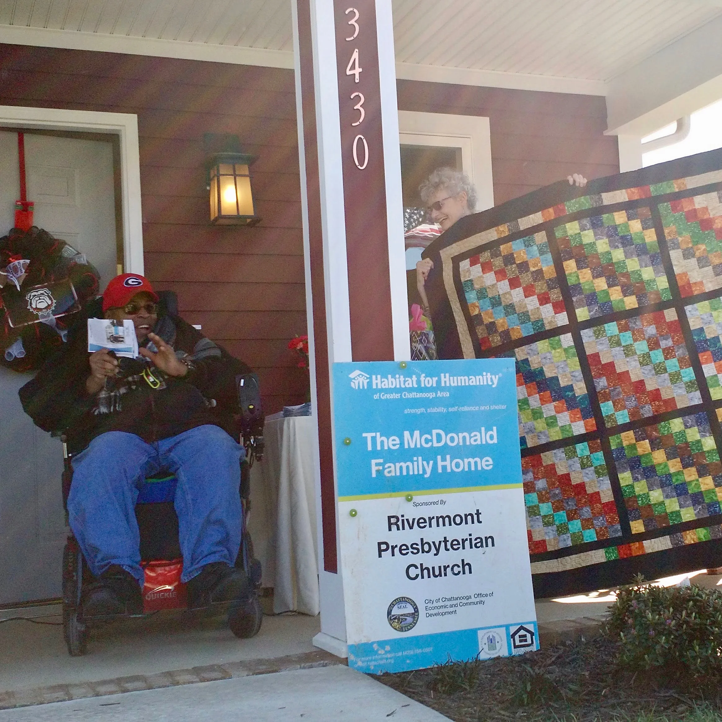 Sidney McDonald (left) received a quilt and the keys to his new house March 3. Photo courtesy of Habitat for Humanity of Greater Chattanooga.