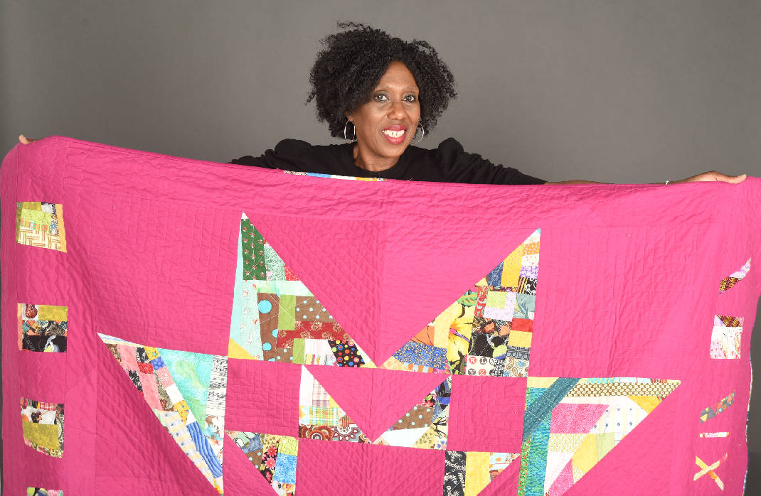 Cornelia Johnson with her quilt. Photo courtesy The Times-Free Press.