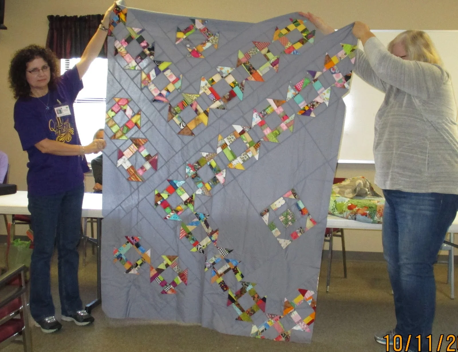 Melissa (left) and Janet (right) show off Team Janet's quilt top
