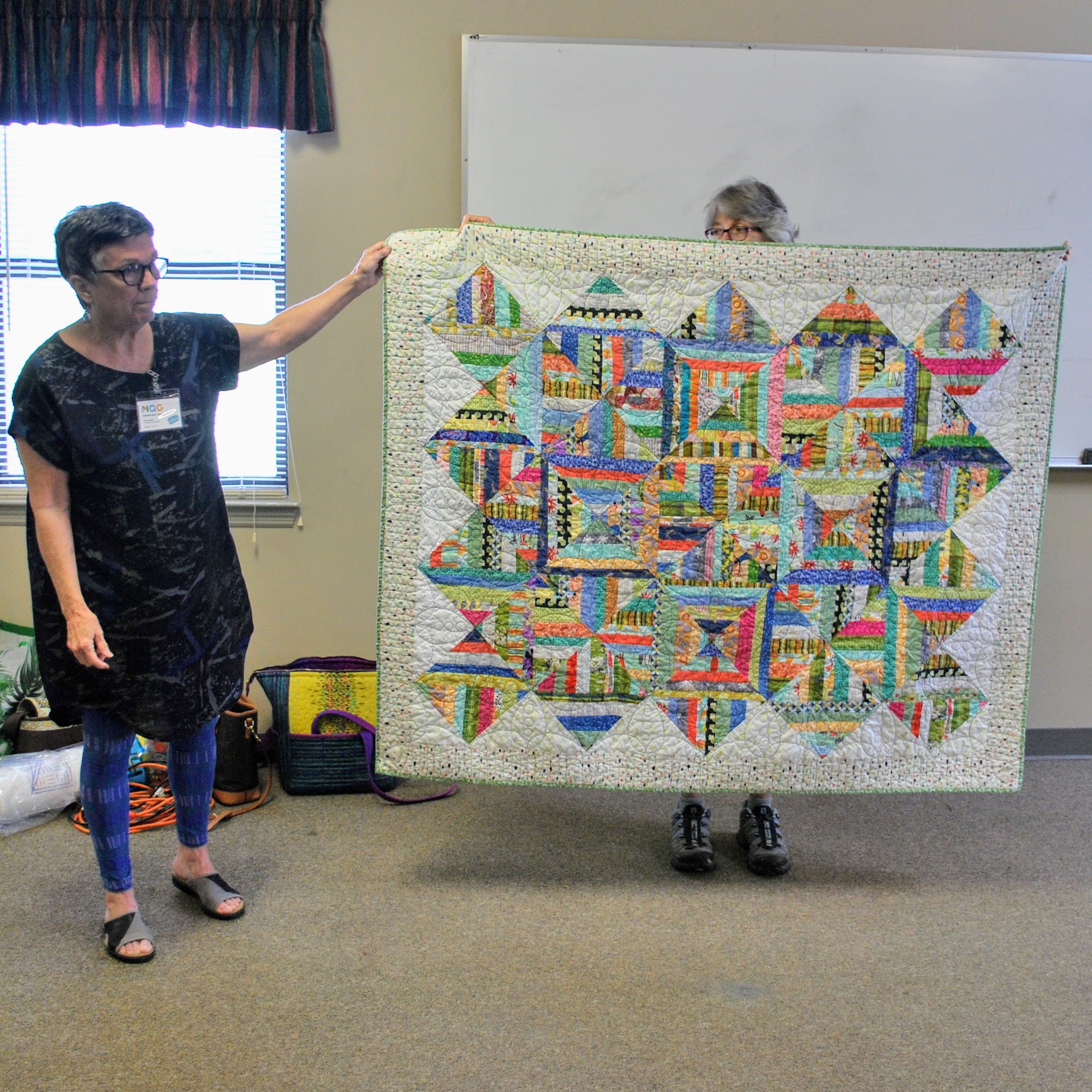 Scrappy strip quilt by Mary Keasler (left)