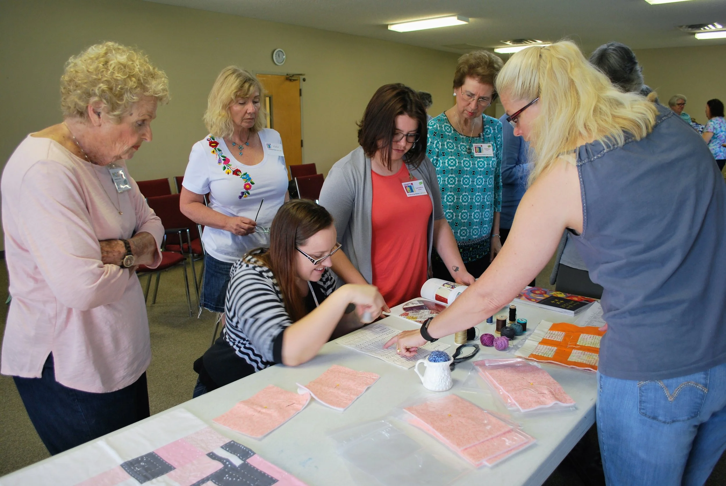 Sara Bradshaw (right) gives ChattMQG members tips for successful utility stitching.