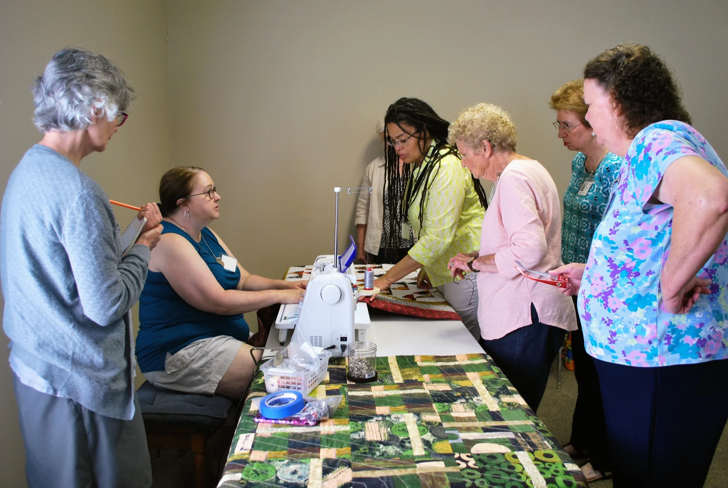 Ava Moore shows ChattMQG members how to use a sewing machine to mimic the look of hand quilting.
