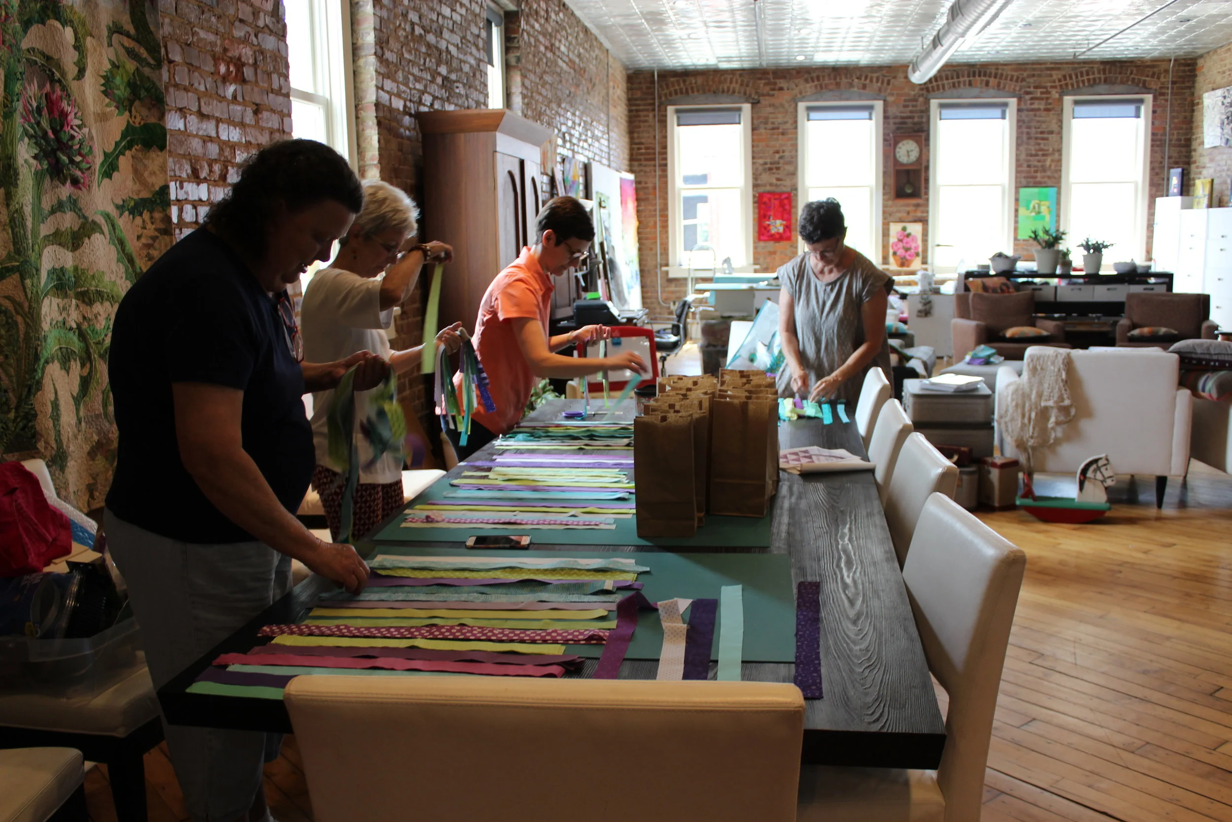 Beverly Herron, Patti Ann Smith, Kelly Spell and Mary Keasler assemble kits for guild members.