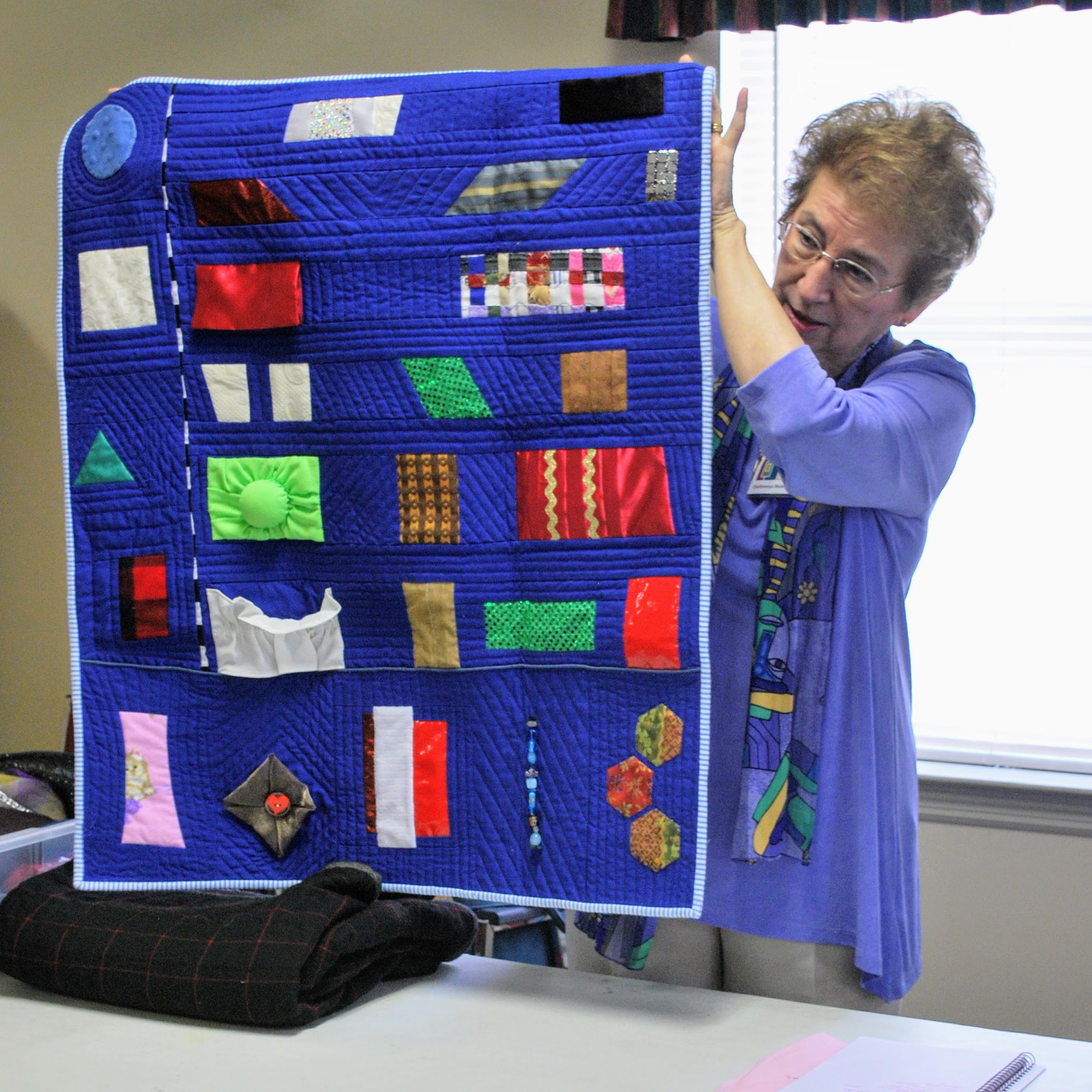 Theresa used a variety of materials to create this tactile sensory quilt for her neighbor.