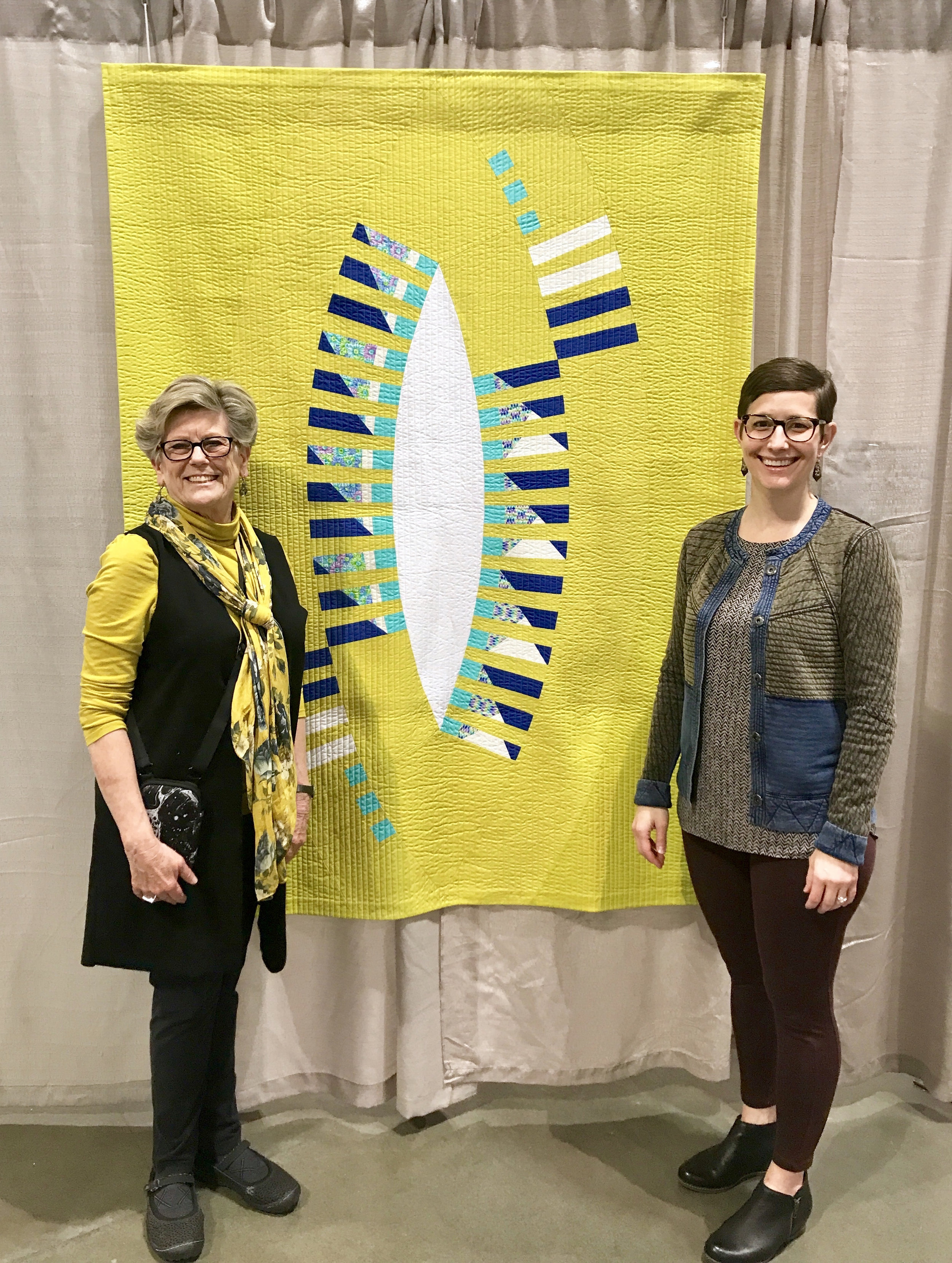 Ann Hurley (left) and Kelly Spell (right) with Kelly's quilt "Felicitous Pickle"