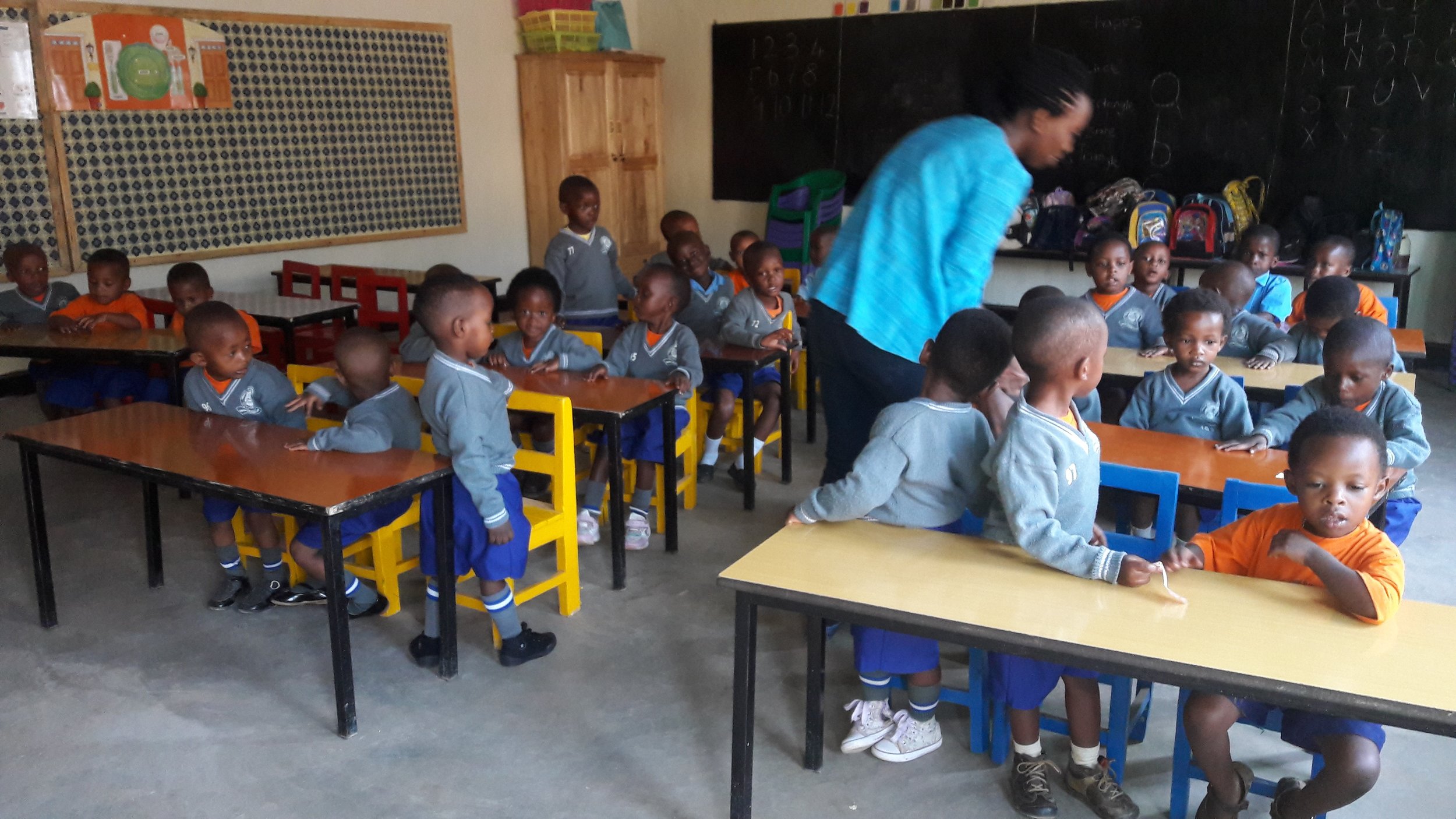 Students in class with chairs, bulletin boards and chairs